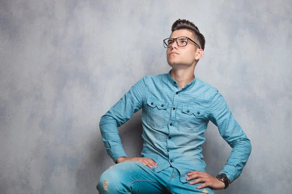 Attractive man sitting while looking up. — ストック写真