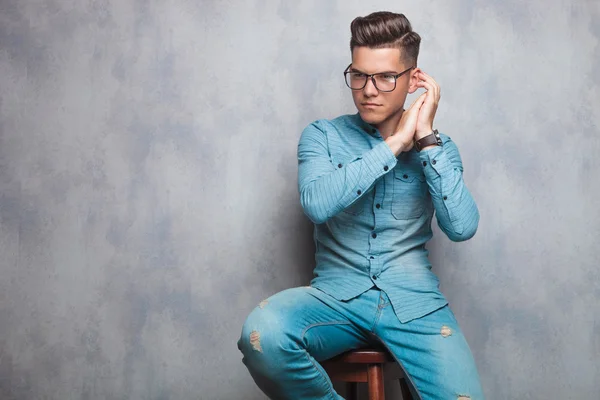 Seated fashion man with palms together — Stok fotoğraf