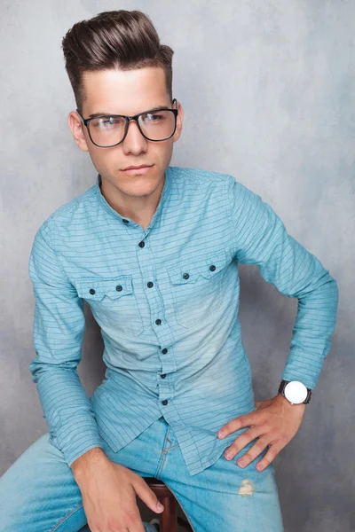 Young casual man sitting on a chair — Stock Photo, Image