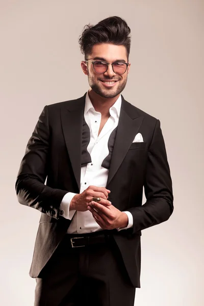 Happy young business man fixing his golden ring — Stock Photo, Image