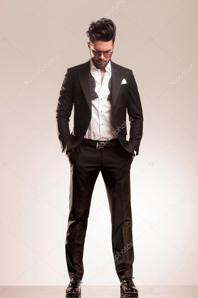 business man standing with both hand in his pocket