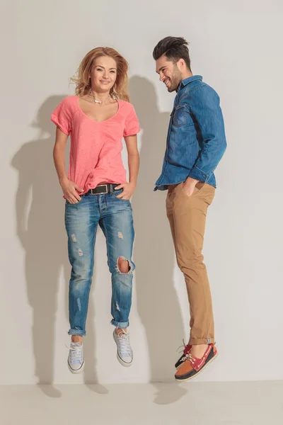 Casual young couple jumping together — Stock Photo, Image