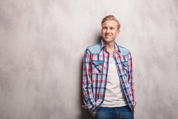 Happy young man smiling away from the camera