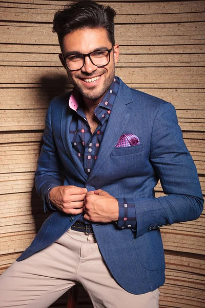 Happy young fashion man sitting on a chair — Stock Photo, Image