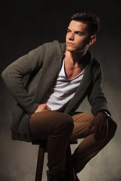 Attractive young man sitting on a chair. — Stock Photo, Image