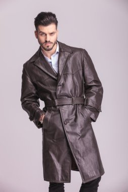 Young business man posing o grey studio background