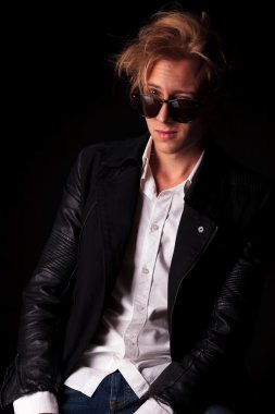 Fashion man posing on black studio background