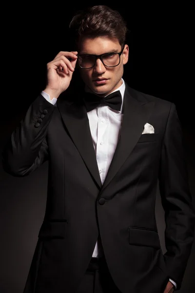 Young business man fixing his glasses. — Stock Photo, Image