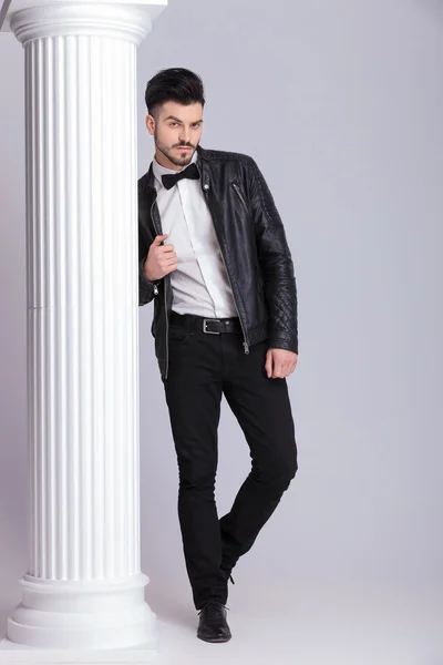 Handsome business man pulling his leather jacket — Stok fotoğraf