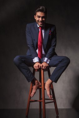 smiling young business man sitting on a chair