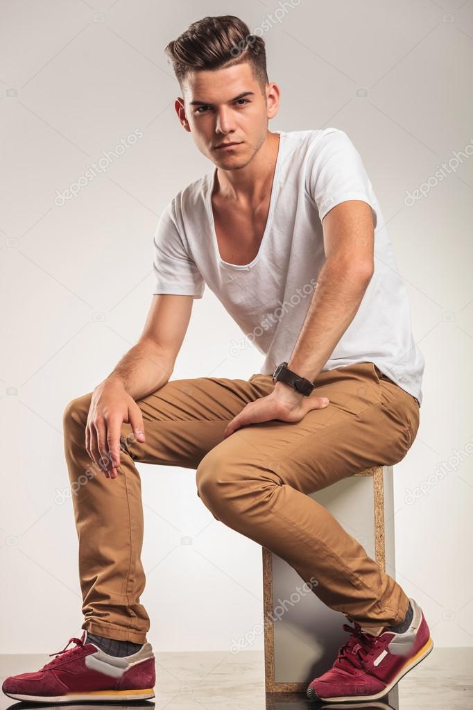 man looking sitting and looking at the camera
