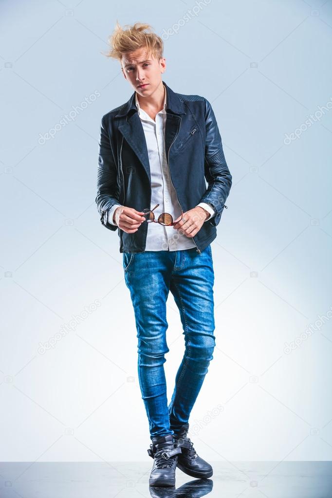 sexy blonde boy wearing jeans and leather jacket while