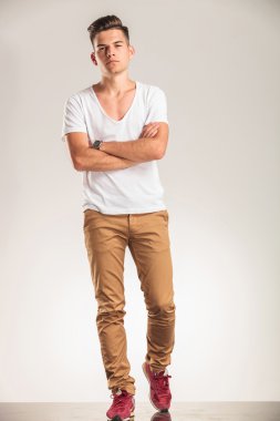 young boy standing with hands crossed