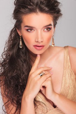 elegant curly girl touching her chin