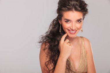 elegant girl smiling while touching her face