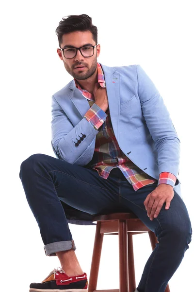 Young casual man relaxing on a chair — Stock Photo, Image