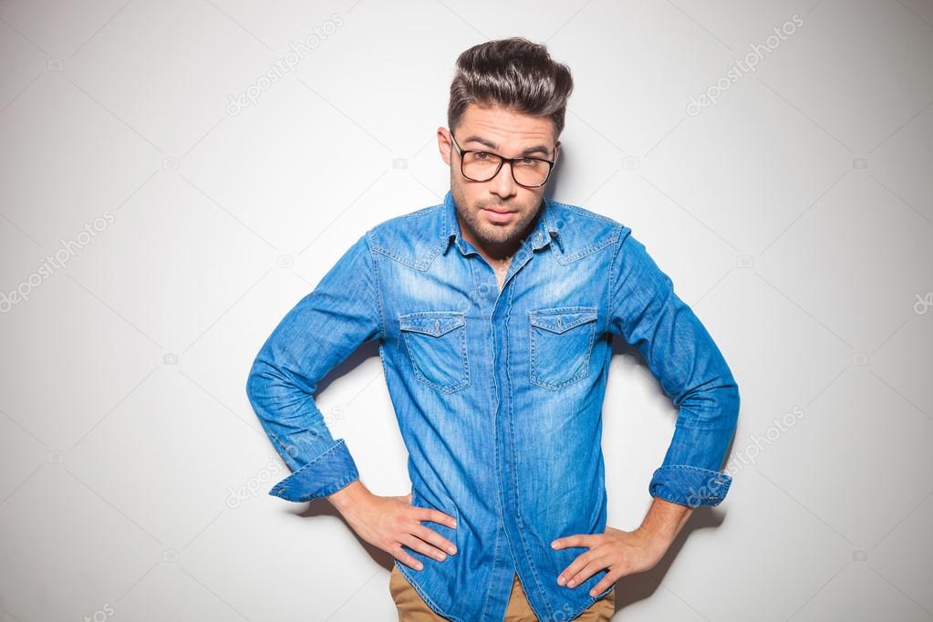 young smart man looking at the camera while wearing denim shirt