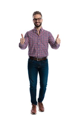 Gözlüklü, kareli tişörtlü, gülümseyen ve beyaz arka planda izole bir şekilde ileriye bakan olumlu bir adam.