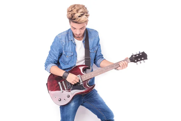 Casual young man playing his electric guitar — Stock Photo, Image