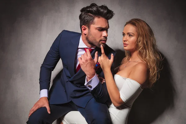 Elegant man is sitting on sexy blonde woman's knees — Stock Photo, Image