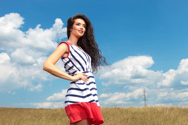 Attractive young woman smiling away from the camera — Stock Photo, Image