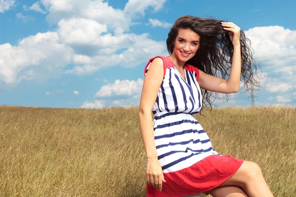 Happy young gorgeous woman fixing her hair — Stock Photo, Image