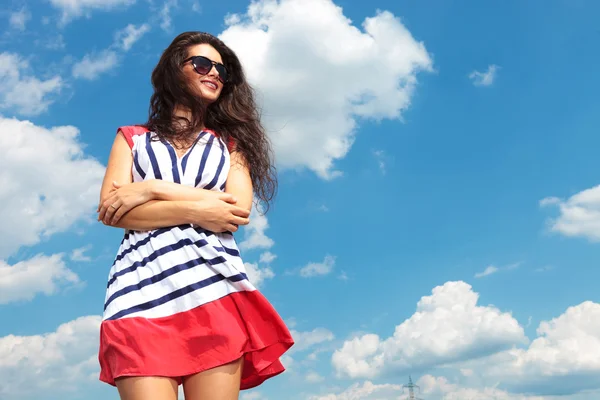 Young brunette woman holding her hands crossed — Stock Photo, Image