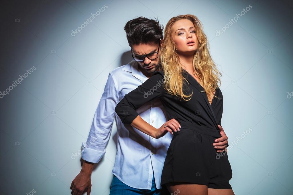 Sexy woman touches her waist while her man holds her close Stock Photo by  ©feedough 87914980