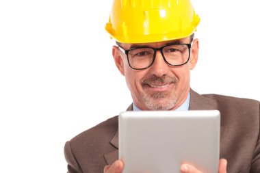 happy senior architect reading on his tablet pad