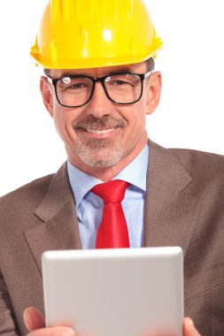 portrait of a smiling construction engineer holding  tablet pad