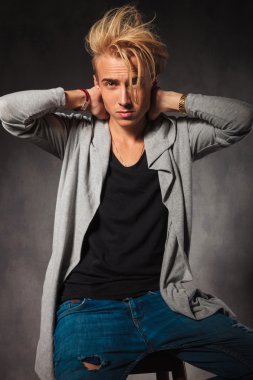 sexy man posing while touching his neck and looking at the camer