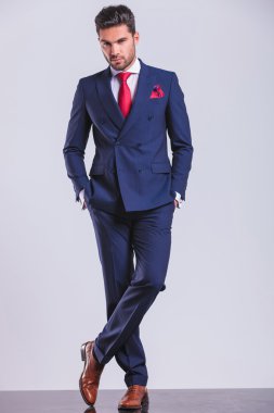 Kurumsal adam ceplerinde iki eliyle kameraya bakan bir