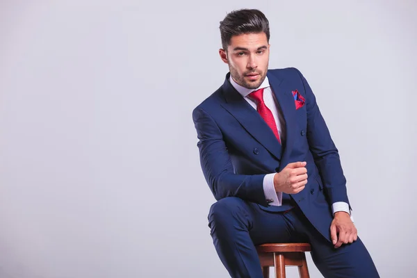 Corporate man leaning on a chair while sitting — Stock Photo, Image