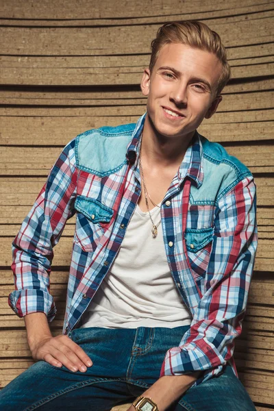 Smiling young man in studio with shirt open — Stock Photo, Image
