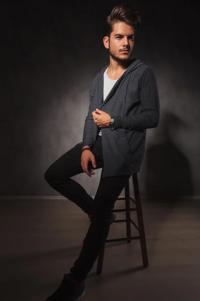 Male model posing in studio while arranging his jacket — Stock Photo, Image