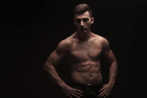 Topless muscular guy posing in dark studio background — Stock Photo, Image