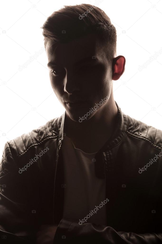 dark portrait of young man in studio background