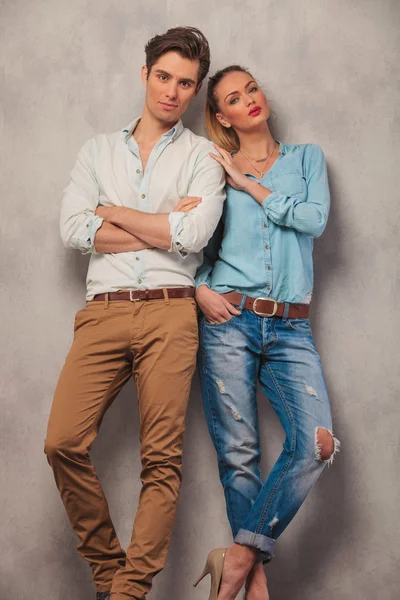 Paar posiert im Studio, Mann mit gekreuzten Händen, während Frau berührt — Stockfoto