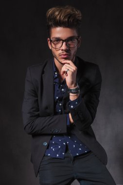 intelligent guy wearing glasses pose seated and thinking