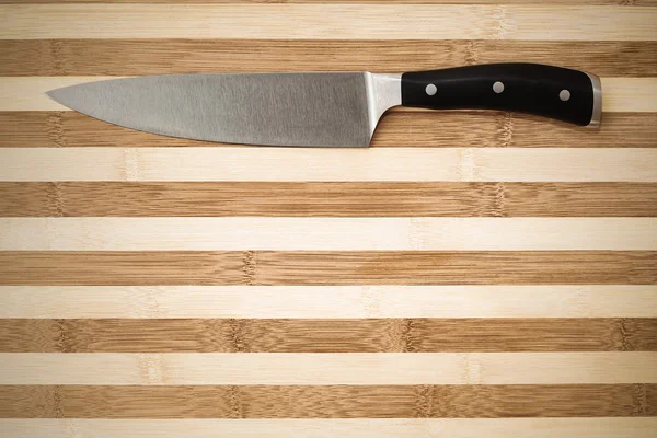 20 cm chef's knife on a bamboo cutting board — Stock Photo, Image