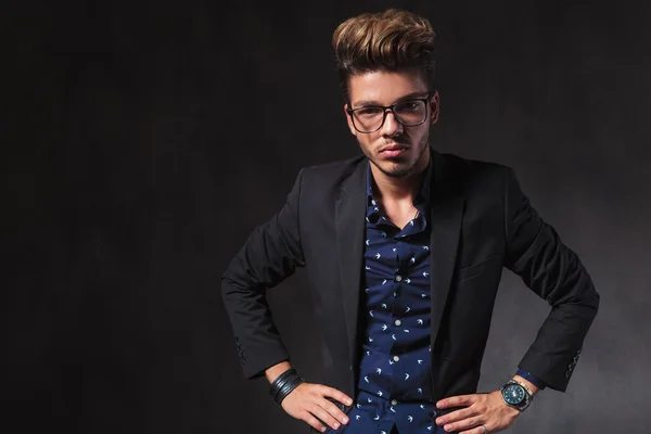 Inteligent handsome man wearing glasses pose in dark studio with — 스톡 사진
