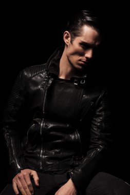 portrait of serious biker in black leather jacket