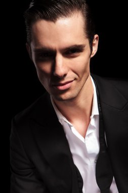 businessman with open shirt smiling in studio 