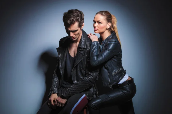 Woman leaning on her man from behind while man in leather jacket — 图库照片