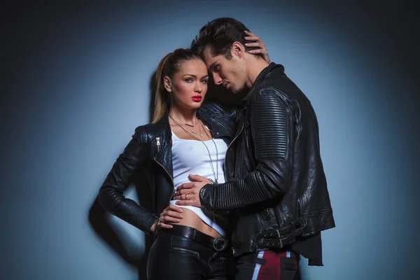 Man in leather jacket leans against his busty girlfriend — Zdjęcie stockowe