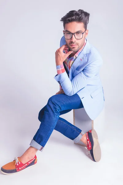 Smart casual man wearing glasses, touching his chin — 图库照片