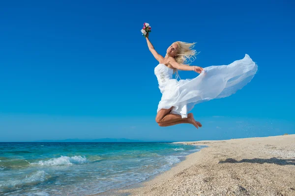 美丽年轻的新娘走在沙滩上 — 图库照片