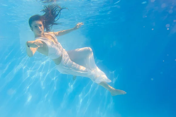 Donna in abito bianco sott'acqua in piscina — Foto Stock