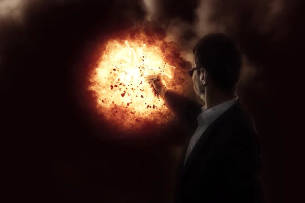 Man with a gun on explosion background — Stock Photo, Image