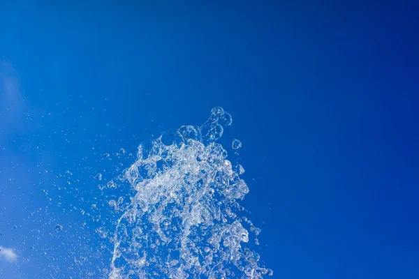 Stream of water divided into droplets